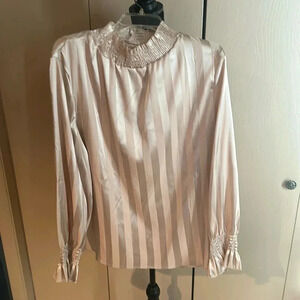 Monochrome satiny stripe blouse w fathered sleeves and mock neck.
